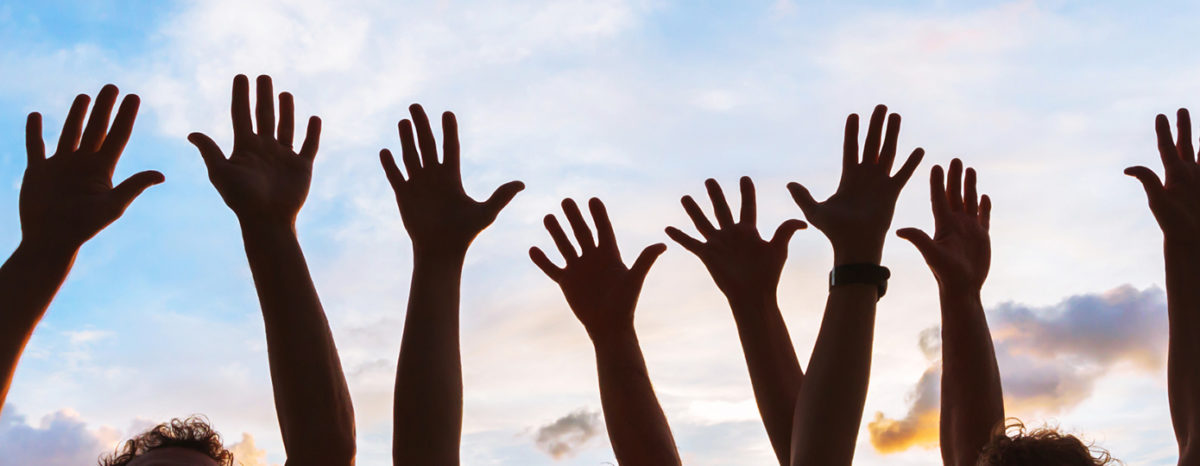 raised hands against the sky