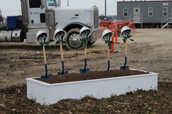 helmets on shovels for ground breaking ceremony