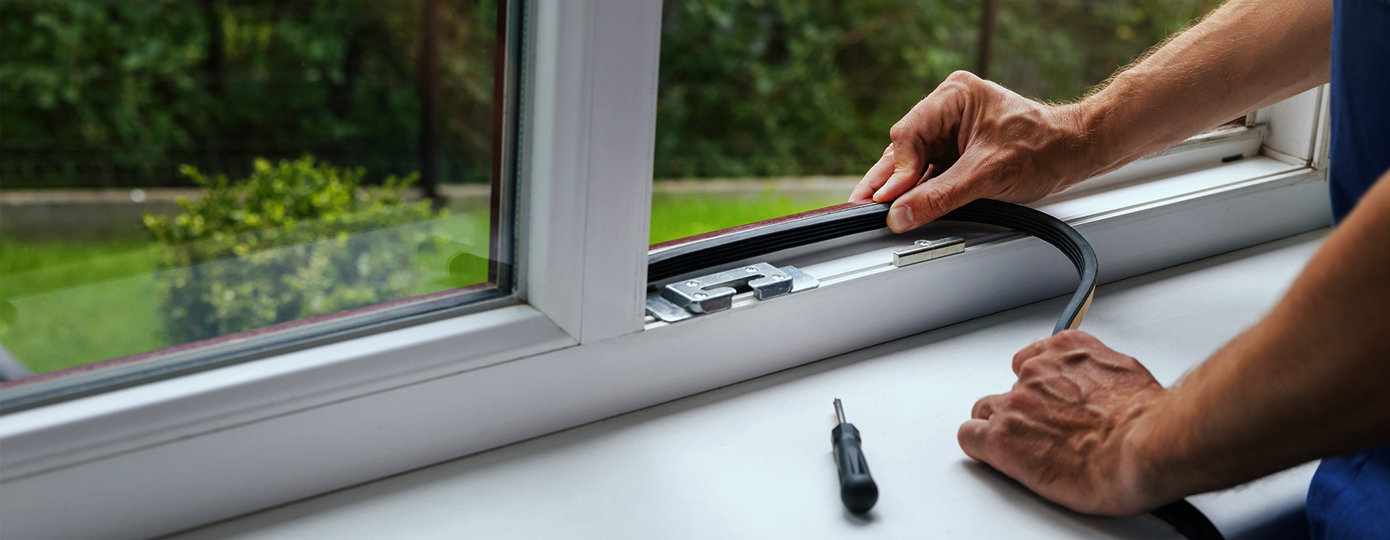 Person weather stripping their window
