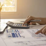 person using calculator for their utility bill