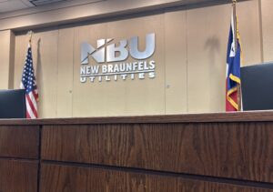 Picture of NBUs Boardroom with the NBU logo on the wall.