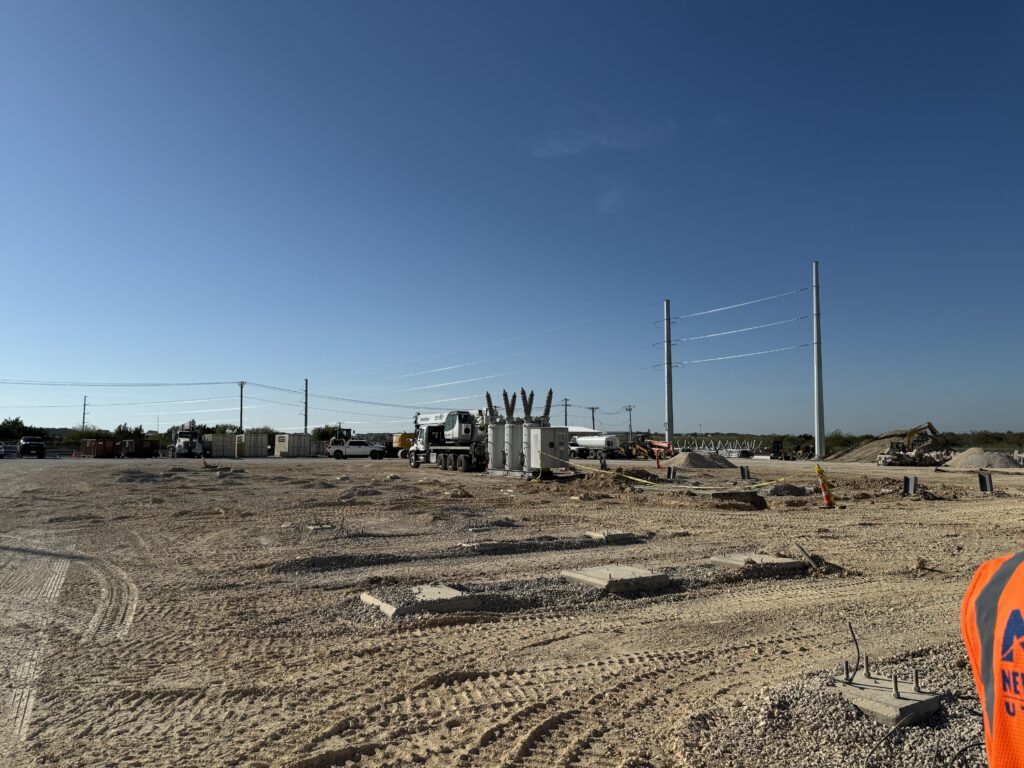 Henne substation upgrade with trucks working to lay poles and transformers.