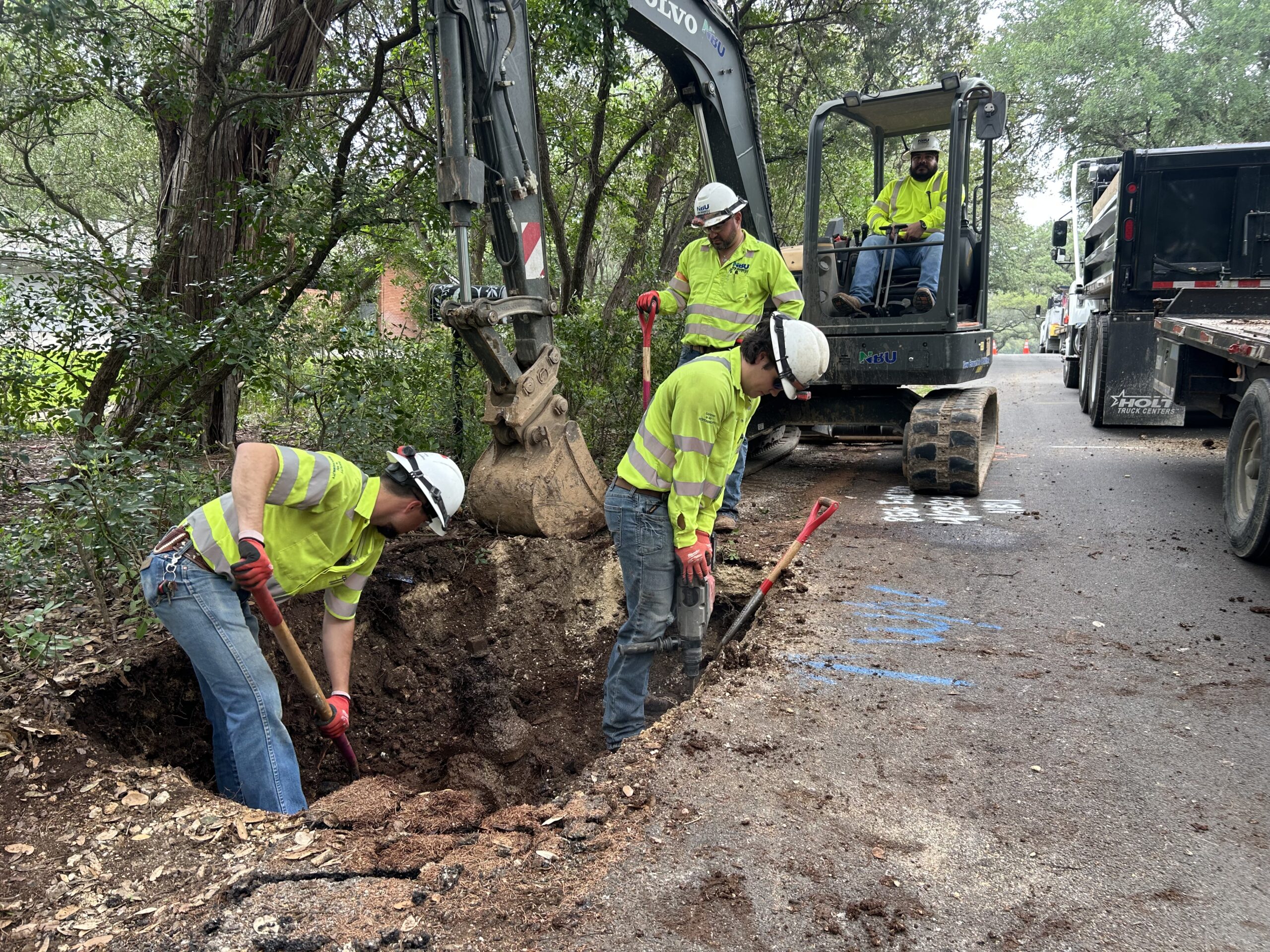 Water crews digging underground to find a water main