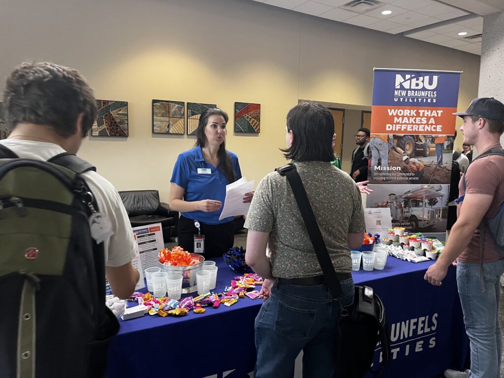 NBU speaking to college students during a career fair