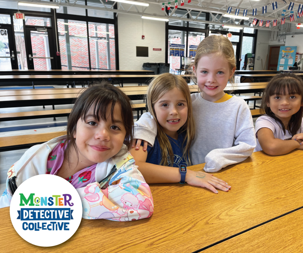 Kids smiling for the camera during a Monster detective presentation