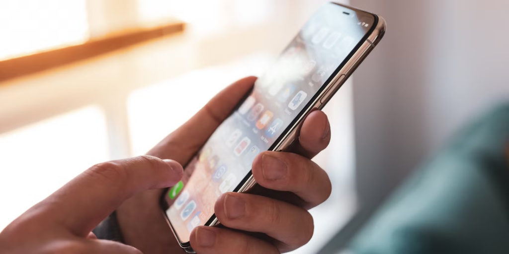 Person scrolling on their phone for emergency updates