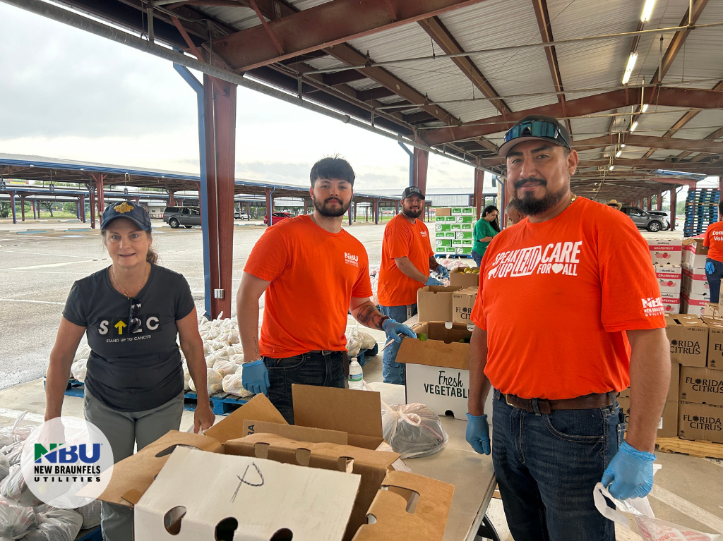Two NBU employees pack boxes at food drive