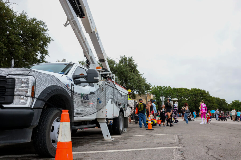NBU bucket truck parked outside of NBU main plaza building.